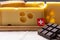 Tasty Swiss food, block of medium-hard yellow cheese emmental or emmentaler with round holes and high quality milk chocolate