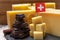 Tasty Swiss food, block of medium-hard yellow cheese emmental or emmentaler with round holes, matured gruyere and high quality