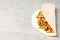 Tasty taco on grey textured background, close up