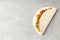 Tasty taco on grey textured background, close up