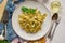 Tasty tagliatelle pasta with basil and green pesto