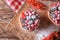 Tasty tartlets with berries on wooden board, top view