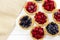 Tasty tartlets with different berries,cranberries,bilberry,blackcurrant . Berry tartlets. Cake with berries. Dessert with berries