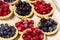 Tasty tartlets with different berries,cranberries,bilberry,blackcurrant . Berry tartlets. Cake with berries. Dessert with berries