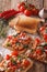 Tasty toast with white beans, tomatoes, cheese and garlic close-up. vertical