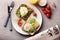 Tasty toasts with avocado and eggs Benedict on plate