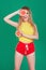 Tasty tropical fruits! Attractive sexual woman in bright sport clothes holding fresh juicy grapefruit or orange near face on isola