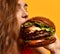 Tasty unhealthy burger sandwich in woman hands hungry mouth getting ready to eat