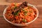 Tasty veg schezwan fried rice served in bowl over a rustic wooden background, Indian cuisine, selective focus