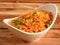 Tasty veg schezwan fried rice served in bowl over a rustic wooden background, Indian cuisine, selective focus