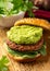 Tasty Vegan meat free burger with guacamole and spinach. Healthy food