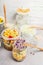 Tasty vegetables salads in jars with corn and sprouts on light rustic kitchen table, close up.