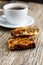Tasty vegetarian granola cake slice with coffee on wooden table.