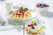 Tasty waffles with berry fruits and whipped cream
