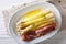 Tasty white asparagus with hollandaise sauce and ham close-up on