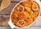 tasty yam pottage decorated with green spices and onion rings