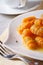 Tasty yellow pumpkin gnocchi with butter, vertical