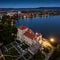 Tata, Hungary - Aerial panoramic view of the beautiful illuminated Castle of Tata Tati var by the Old Lake Oreg-to at dusk