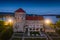 Tata, Hungary - Aerial view of the beautiful illuminated Castle of Tata by the Old Lake Oreg-to at dusk with clear blue sky