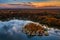 Tata, Hungary - Beautiful autumn sunset over wooden fishing cottages on a small island at Lake Derito Derito-to in October