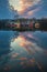 Tata, Hungary - Beautiful sunset over wooden fishing cottages on a small island at Lake Derito