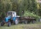 Tatarstan, Russia - 25 august 2018 - young man sitting in the carriage with sawn trees. tractor