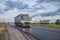 Tatarstan / Russia - July 05 2020: A Mercedes truck is driving along a large highway. In the oncoming lane there is a large traffi