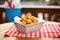 tater tots in a basket with a red and white napkin