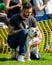 A tatooed man with a dog in the park at a dog show