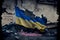 Tattered and torn Ukrainian flag in a city street