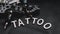 Tattoo accessories With inscription tattoo of wooden letters - black background