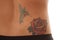 Tattoo close rose on lower back