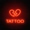 Tattoo parlor glowing neon signboard with emblem. Broken heart glowing logo on a brick wall background.