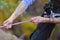 Tattooed climber grips the rope for abseiling down the mountain face