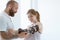 Tattooed physiotherapist who puts an orthosis on the hand of a young patient