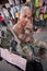 A tattooed salesman sitting in front of his stall in the Chatuchak weekend market in Bangkok