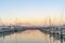 Tauranga Marina boats and piers reflected in calm water at sunrise