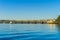 Tauranga Railway bridge catches glow from sunrise in distance across  blue calm water