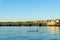 Tauranga Railway bridge catches glow from sunrise in distance across  blue calm water