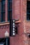 Tavern sign against a brick building exterior