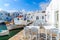 Tavern tables and boats in Naoussa fishing port, Paros island, Greece