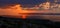 Tawny and cloudy Sunset silhouetting Gozo Island