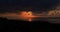 Tawny and cloudy Sunset silhouetting Gozo Island