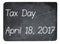 Tax Day concept using chalk on slate blackboard