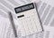 Tax deadline inscription on white calculator on financial documents