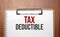 TAX DEDUCTIBLE text on white paper on the wood table