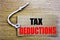 Tax Deductions. Business concept for online saleFinance Incoming Tax Money Deduction written on price tag paper with copy space on