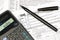 Tax forms, calculator and pen