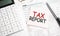 Tax forms with pen, calculator, glass and sticker. Tax report sign