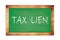 TAX  LIEN text written on green school board